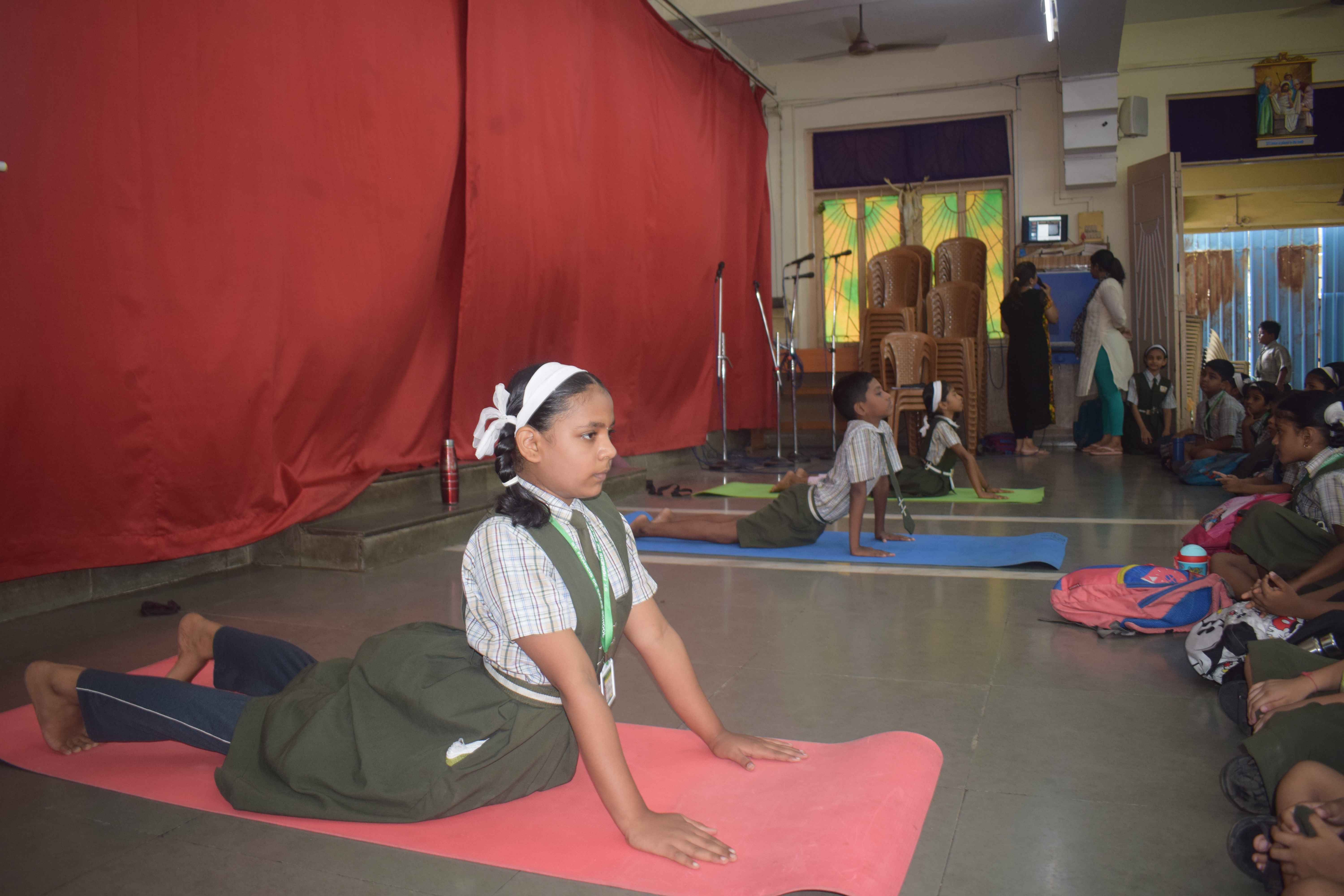 Students practicing on yoga mats